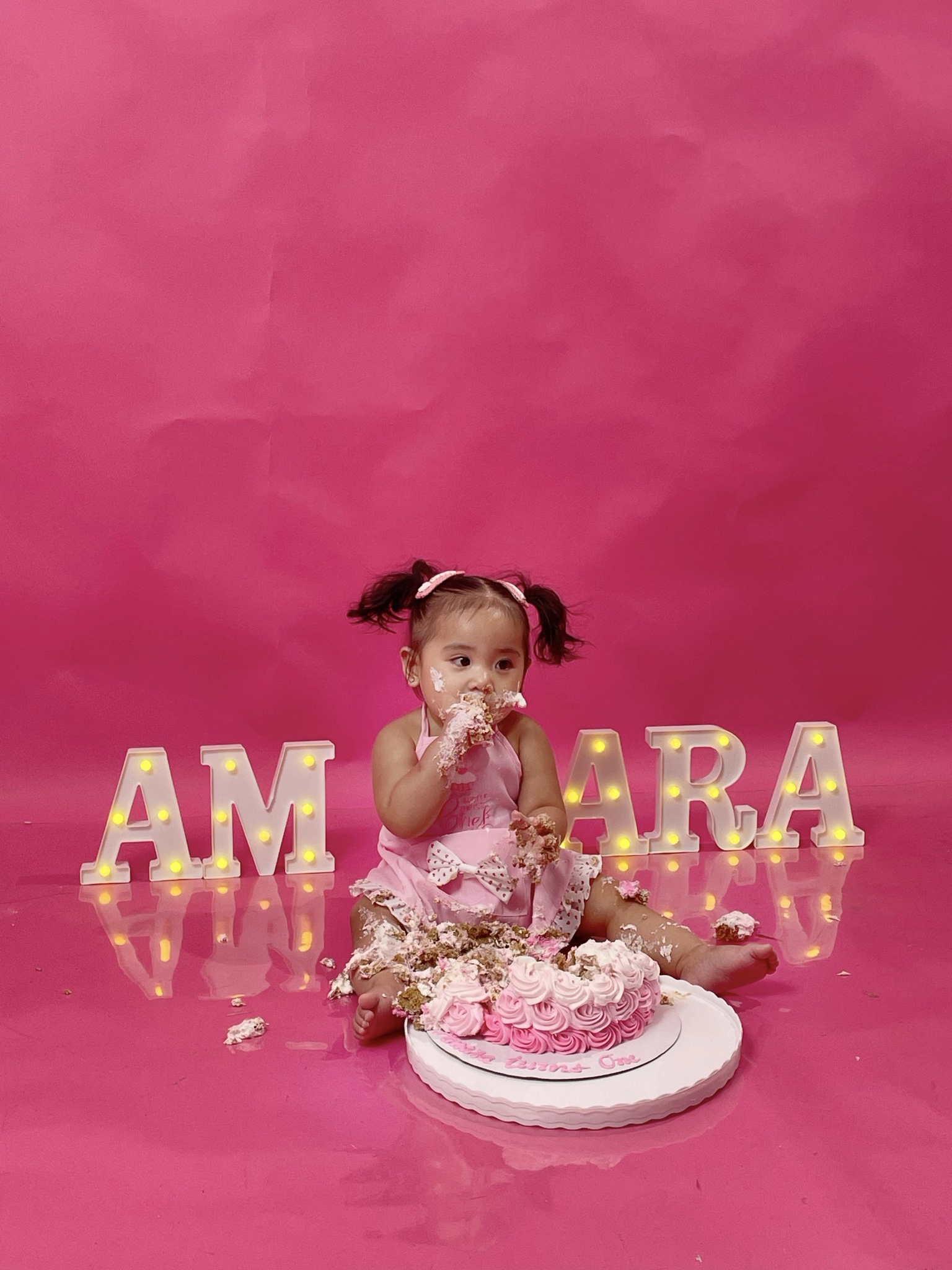 Amara enjoying her fairy birthday cake smash